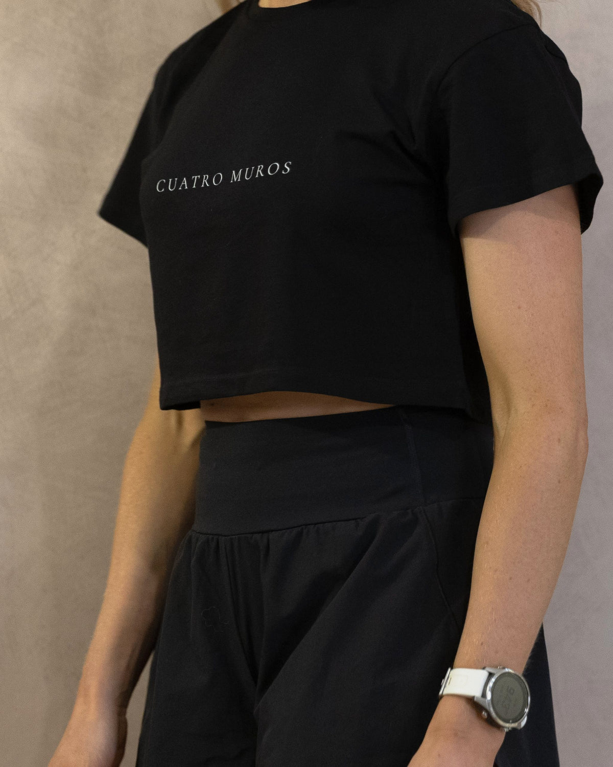 The Cristal Crop in Black, three-quarter front, worn by a 5ft 6 model in size XS
