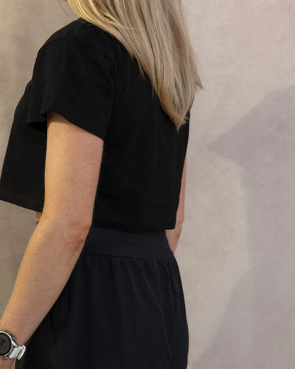 The Cristal Crop in Black, back three-quarter, worn by a 5ft 6 model in size XS