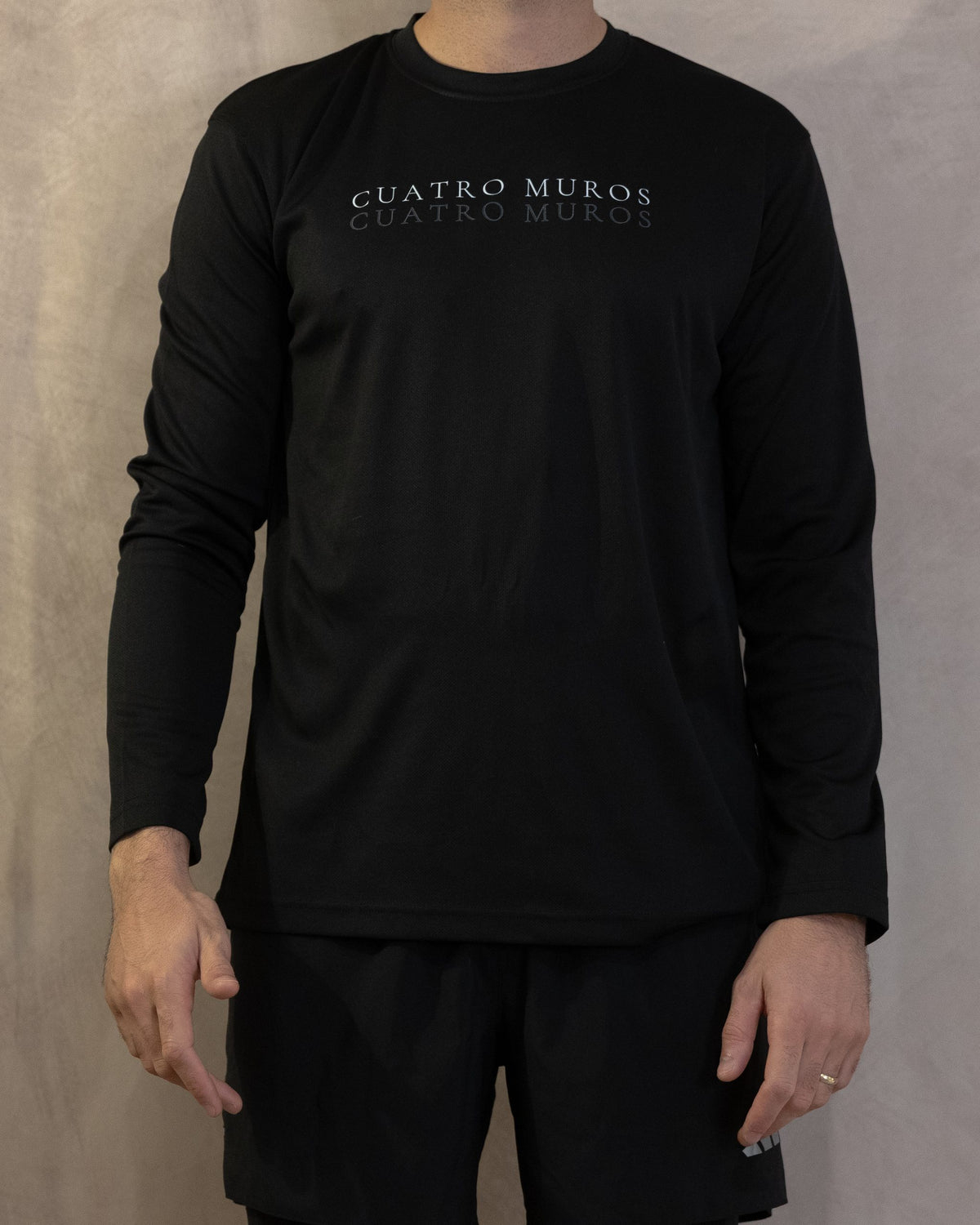 The Fondo Long Sleeve in Jet Black, three-quarter front, worn by a 6ft model in size Large