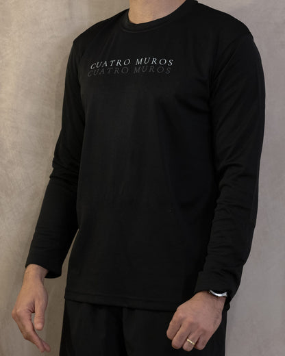 The Fondo Long Sleeve in Jet Black, front, the double wordmark printed across the chest, worn by a 6ft model in size Large