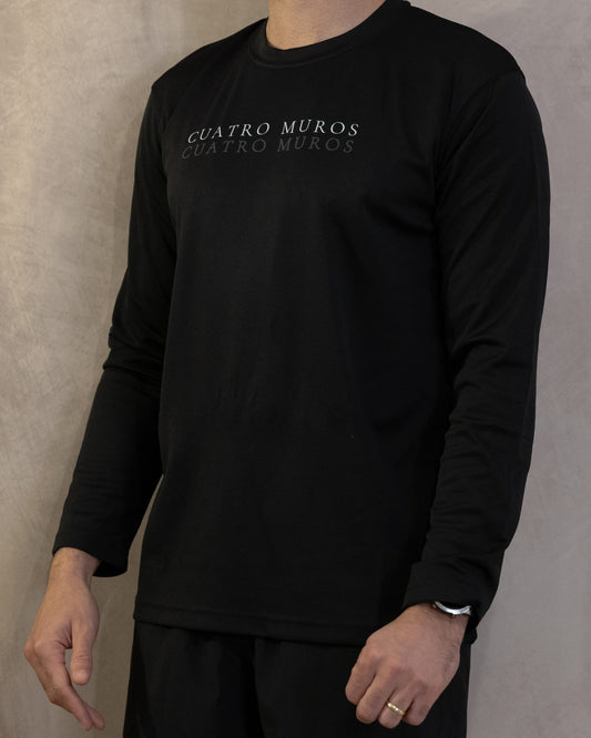 The Fondo Long Sleeve in Jet Black, front, the double wordmark printed across the chest, worn by a 6ft model in size Large