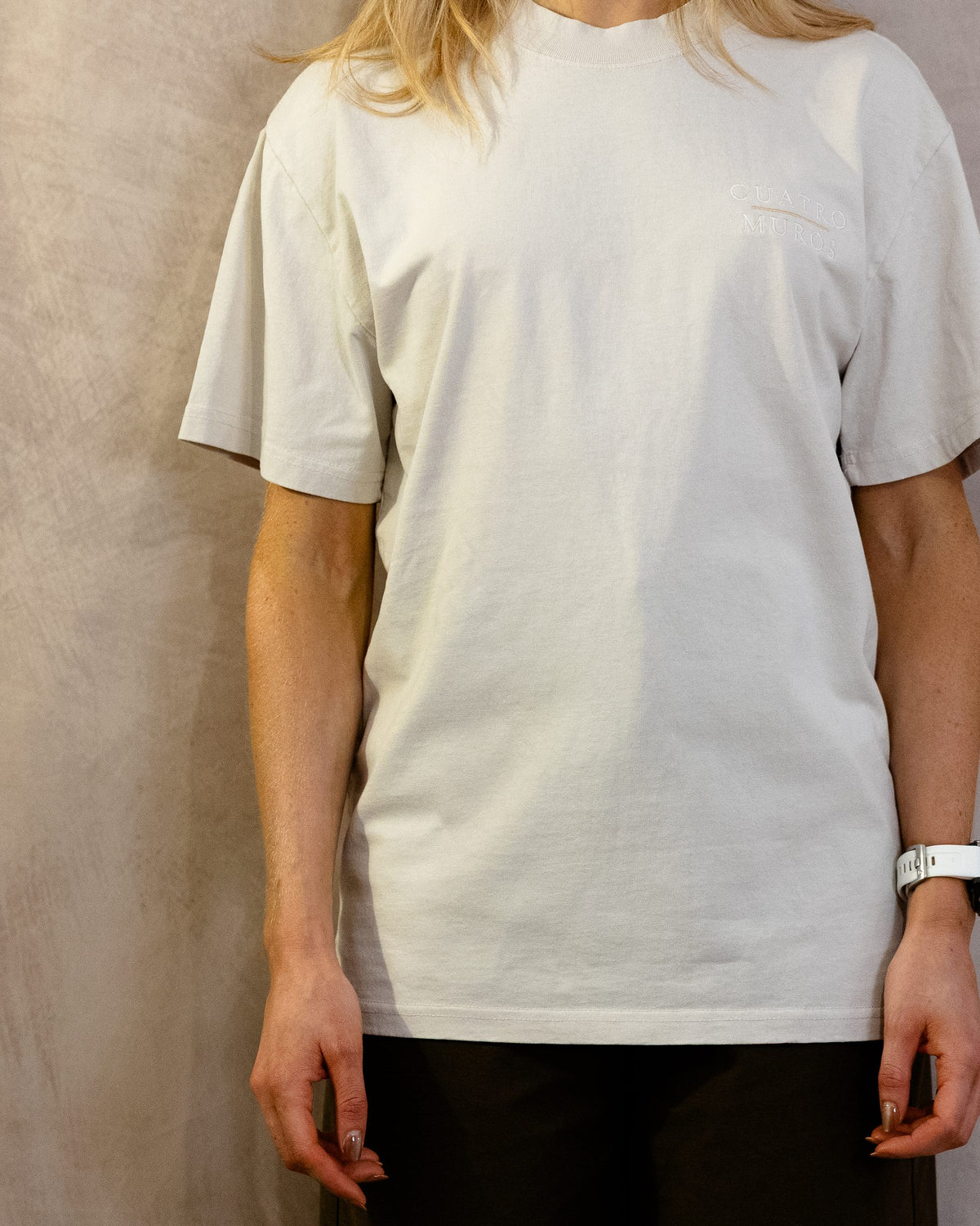 The Muro Tee in Faded Bone, front, worn by a 5ft 6 model in size Small