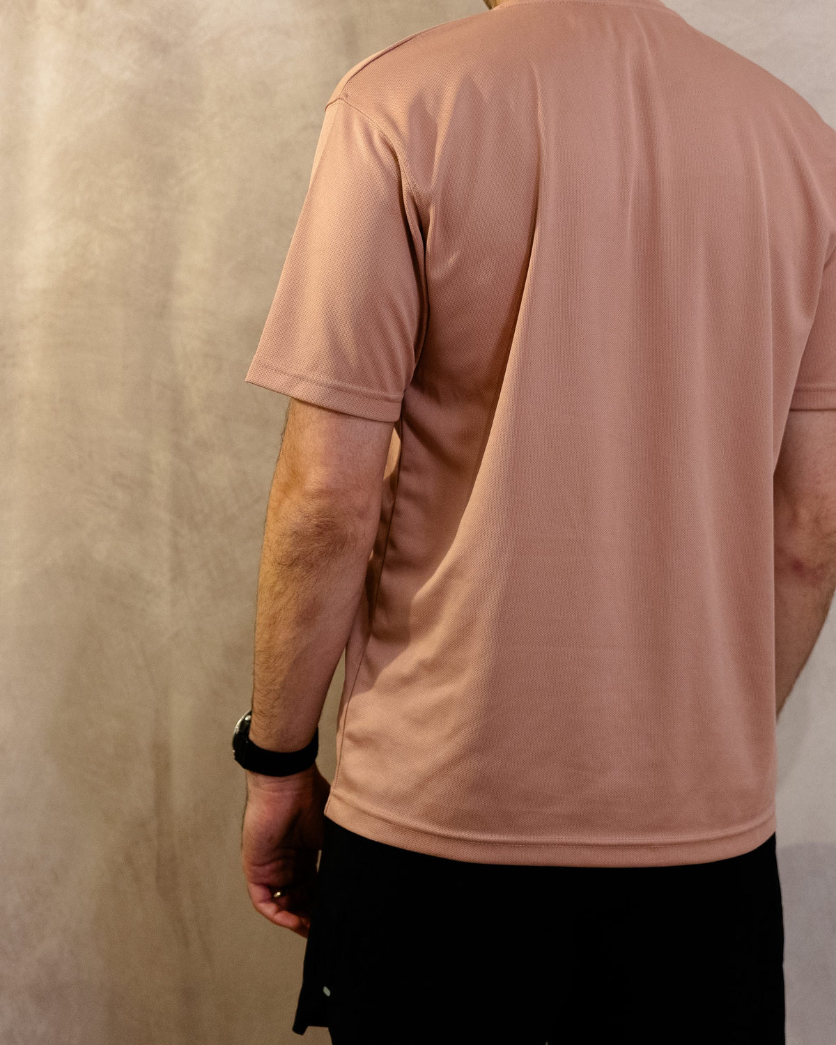 The Sombra Tee in Dusty Pink, back, worn by a 6ft model in size Large